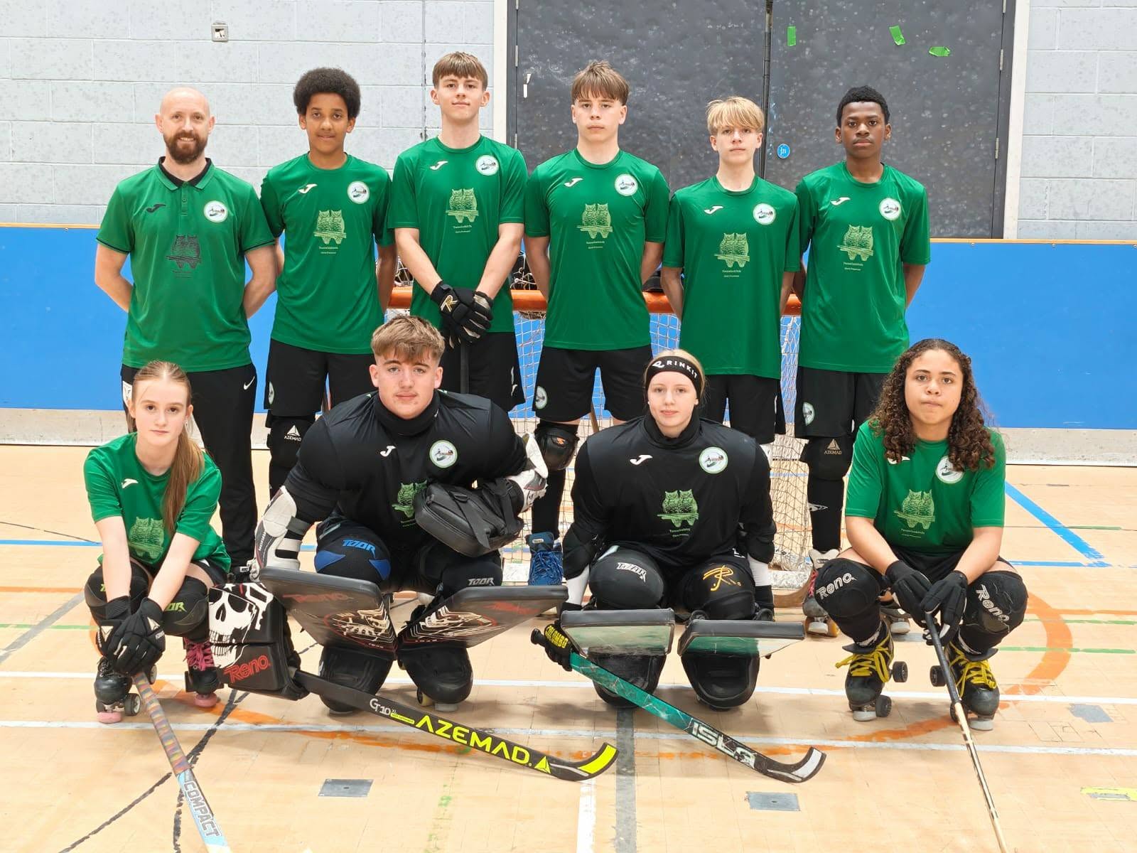 A junior squad lined up before a match with a coach