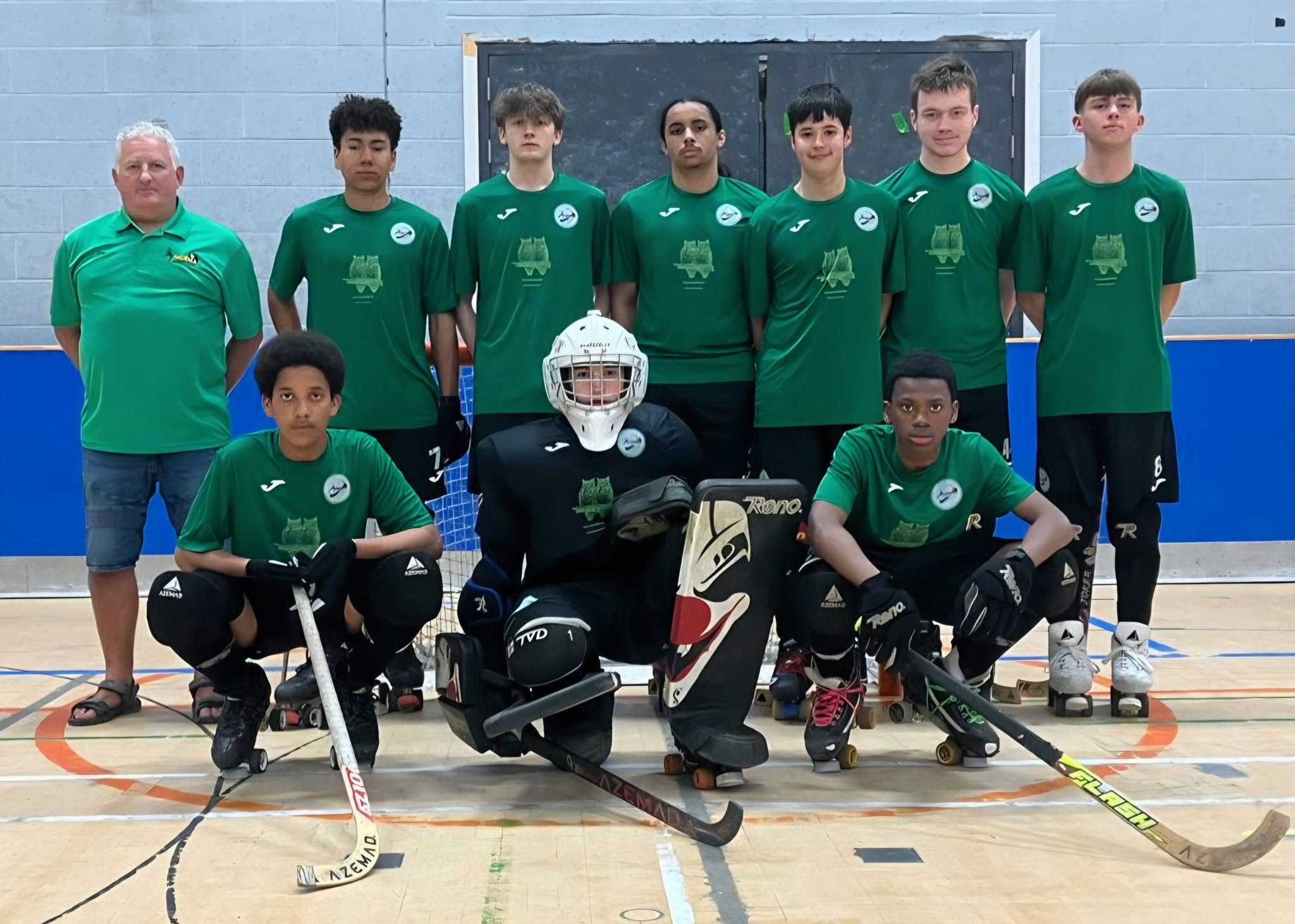 A senior squad lined up in a sports hall